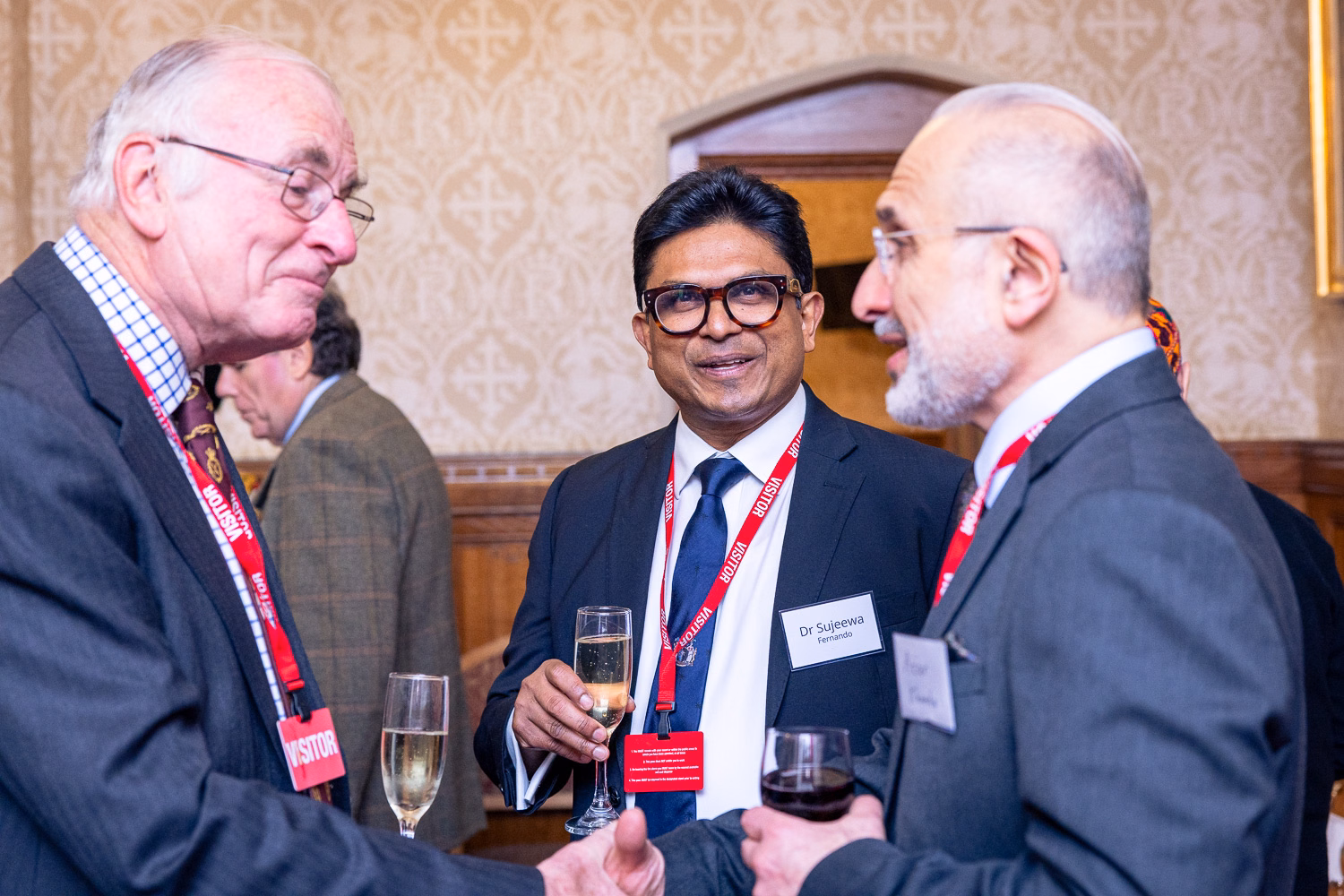 Three men in suits chatting