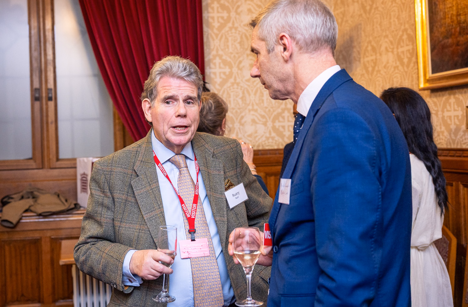 Two men in discussion wearing suits