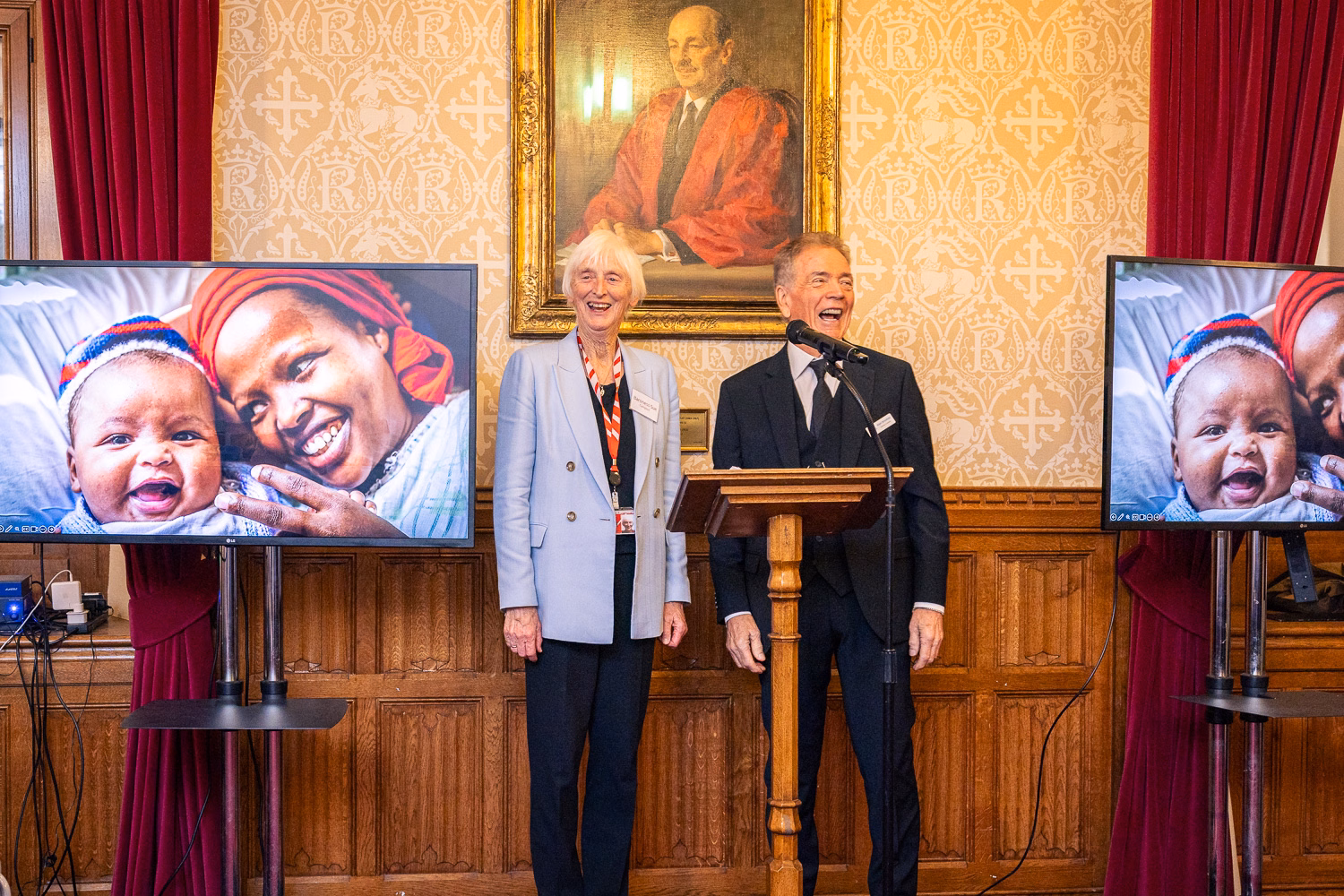 Baroness Campbell and Nigel Brooksby stand at a podium